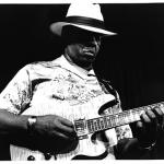 Photograph of W. C. Clark playing his guitar